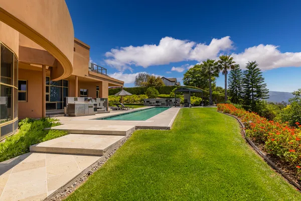 a view of a fountain in front of a brick house