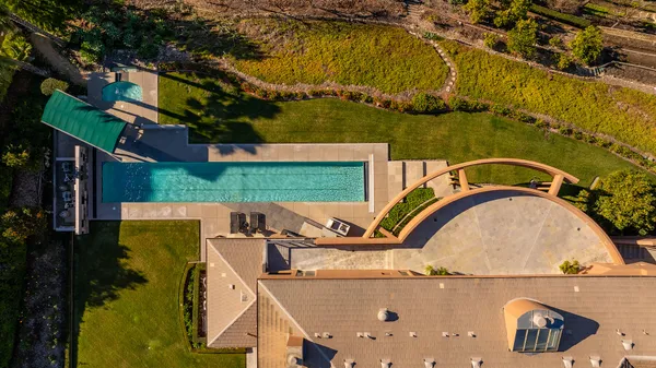 an aerial view of a house with a swimming pool