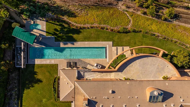 an aerial view of a house with a swimming pool