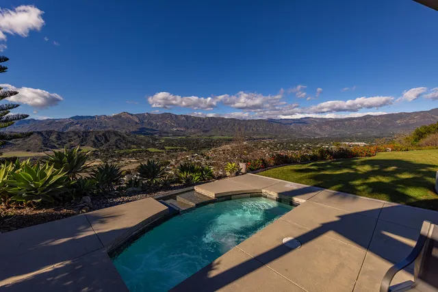 a view of a house with a yard and a swimming pool