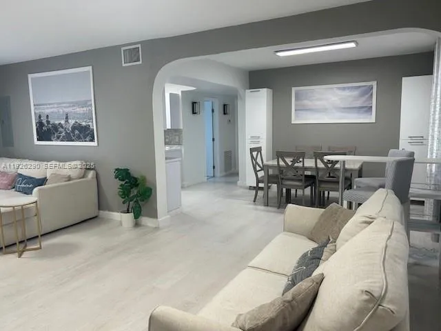 a living room with furniture and a potted plant