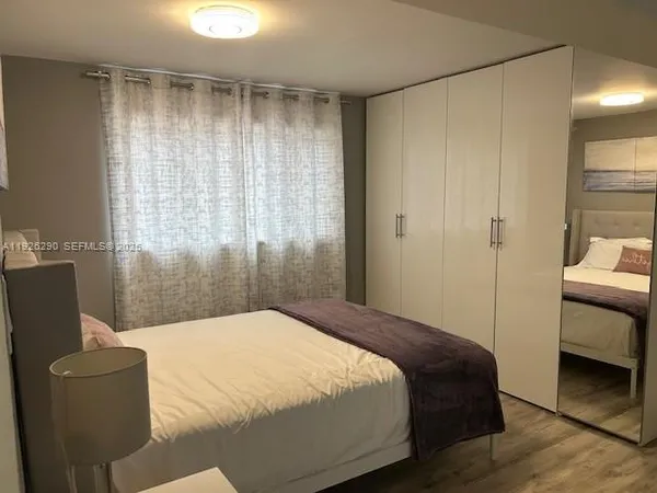 a bedroom with a bed and a couch