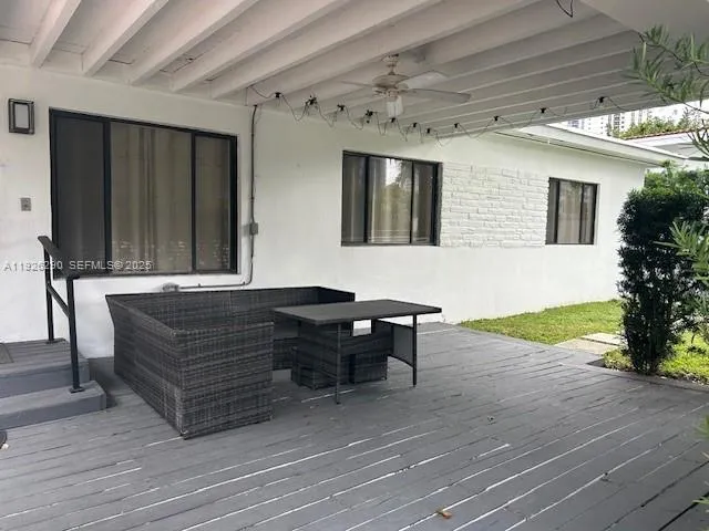 a couch sitting in a room next to a yard