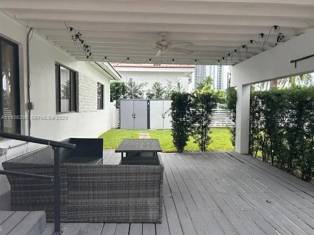 a view of a patio with table and chairs potted plants with wooden floor