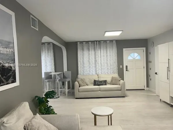 a living room with furniture and a large window