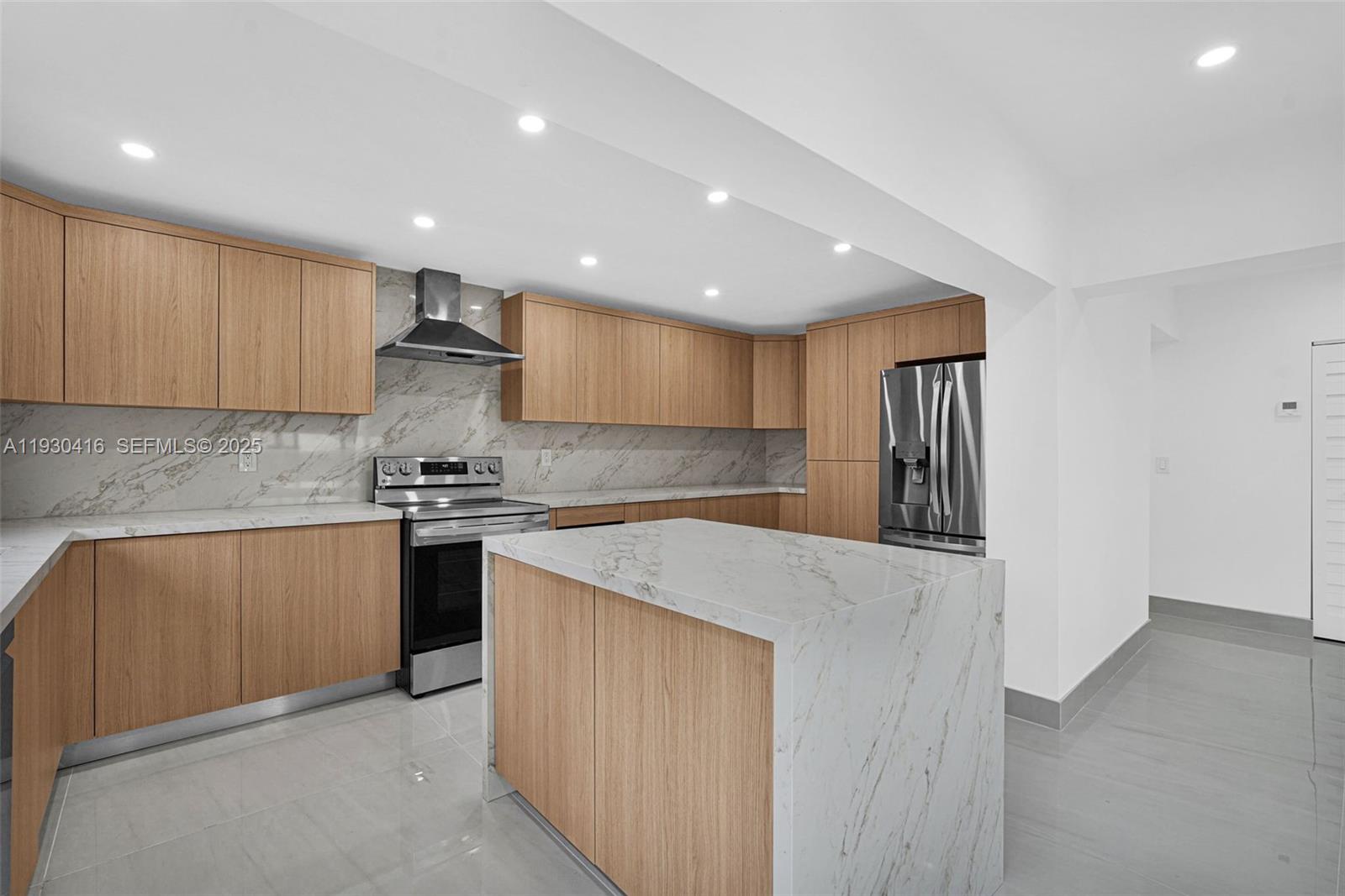 998 Southwest 11th Street Miami, FL 33129 - Photo 13 of 66 a kitchen with stainless steel appliances granite countertop a refrigerator a sink a stove and white cabinets