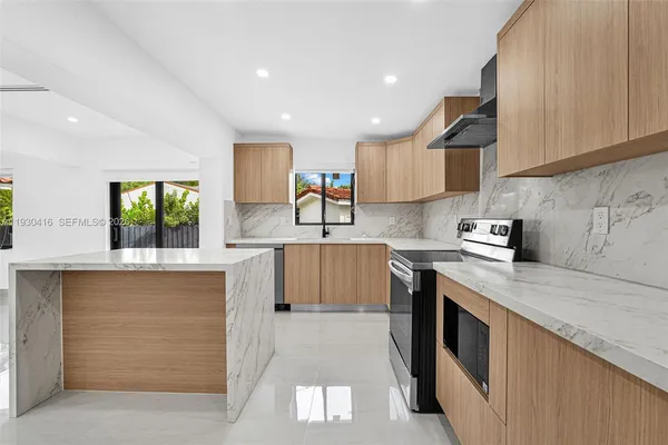 a large kitchen with lot of cabinets and a stove