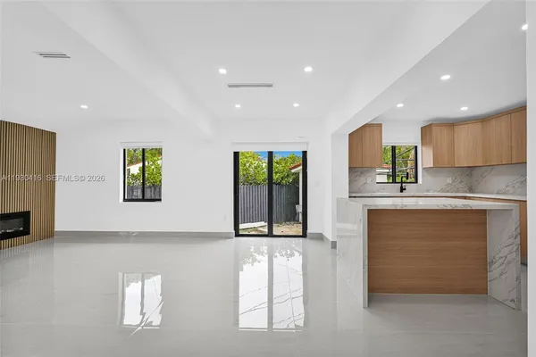 an empty room with fireplace and windows