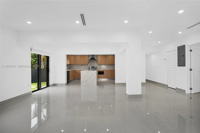 an empty room with fireplace and windows