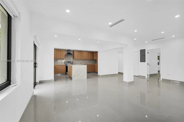 an empty room with large windows