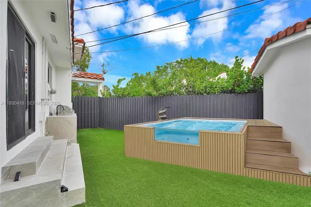 a view of a backyard with sitting area