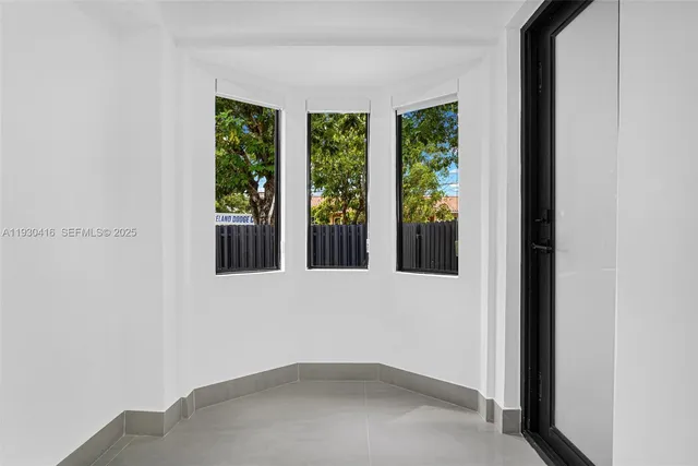 a view of an empty room with glass door