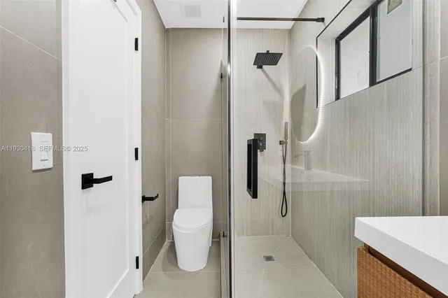 a bathroom with a sink a toilet and a mirror
