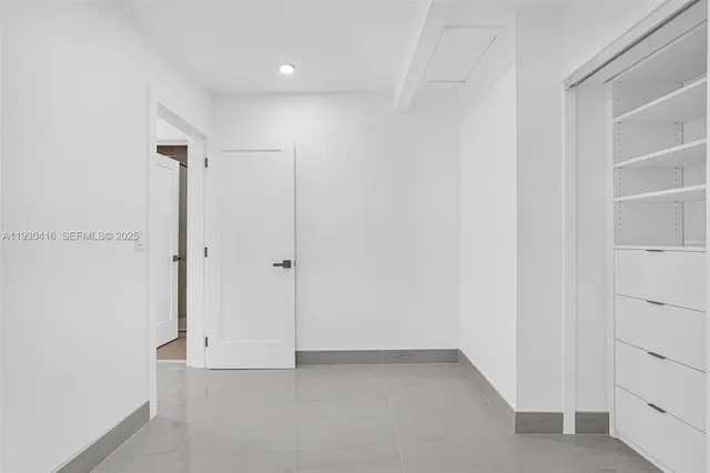 a white house with a small yard and wooden fence