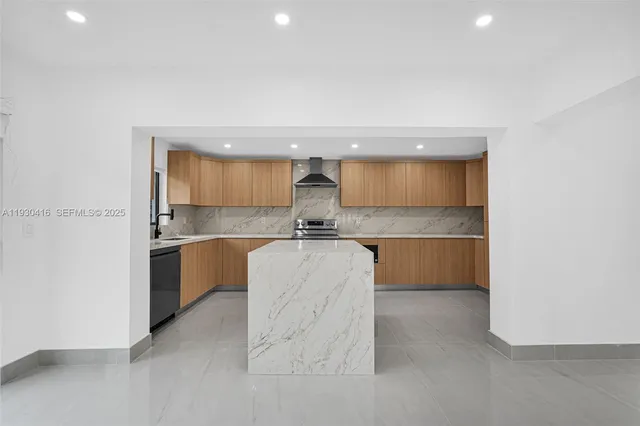 a kitchen with stainless steel appliances granite countertop a sink stove and cabinets