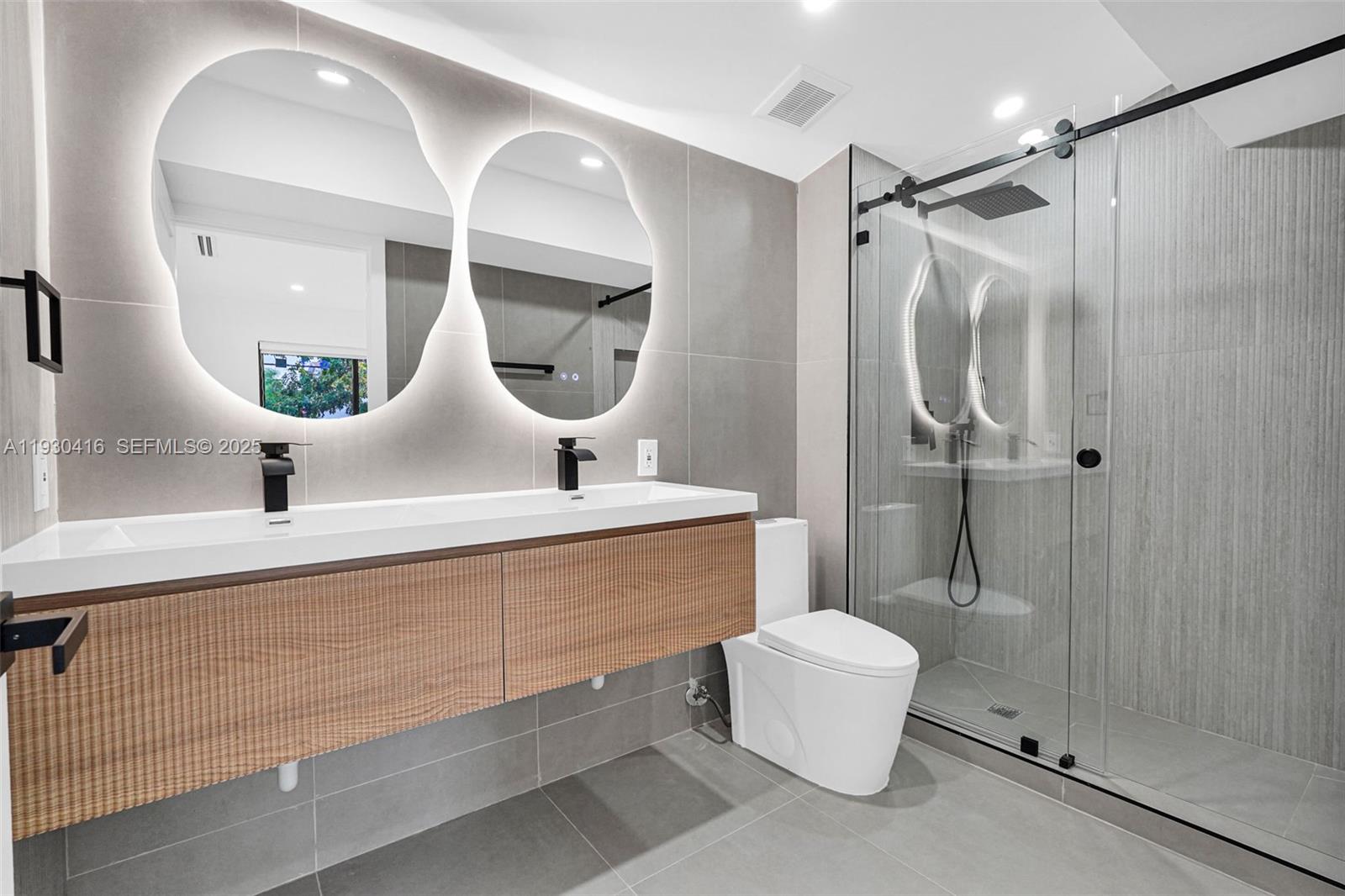 998 Southwest 11th Street Miami, FL 33129 - Photo 44 of 66 a bathroom with a sink mirror toilet and shower