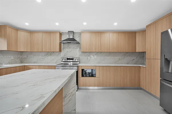 a kitchen with stainless steel appliances granite countertop a sink stove and cabinets