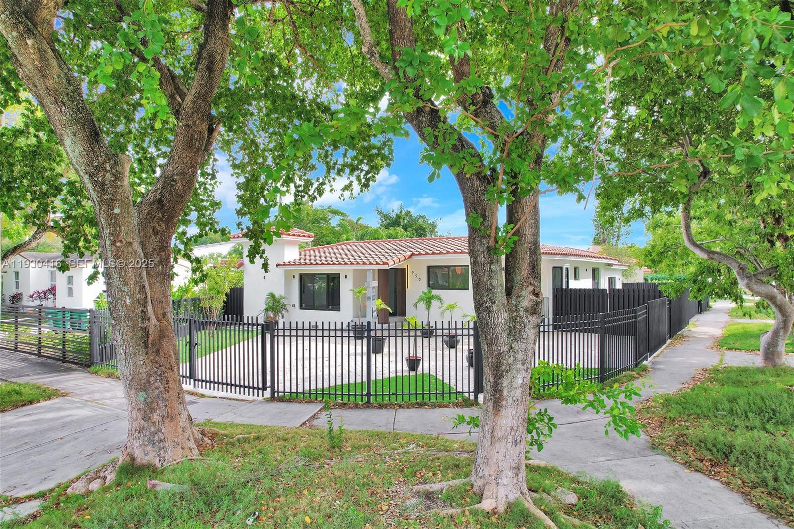 998 Southwest 11th Street Miami, FL 33129 - Photo 64 of 66 a front view of a house with a yard and an tree