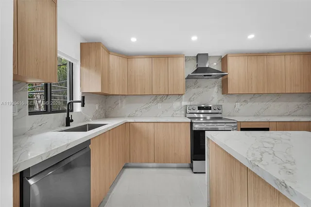 a kitchen with stainless steel appliances granite countertop a sink stove and cabinets