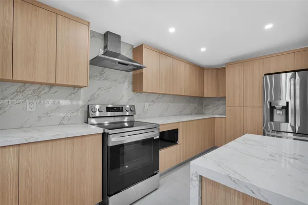 a kitchen with stainless steel appliances granite countertop a sink and a stove