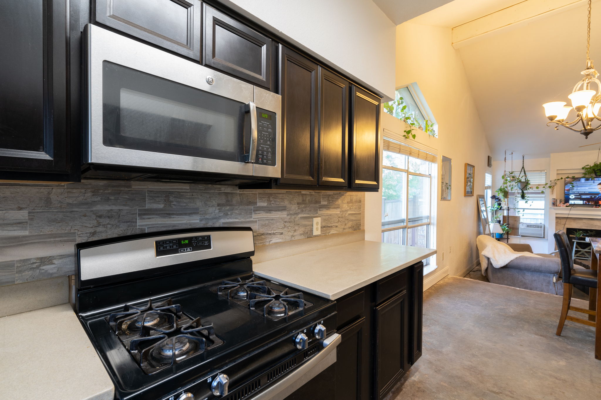 5611 Meadow Crest Austin, TX 78744 - Photo 13 of 29 a kitchen with a stove and a microwave