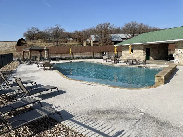 a view of a swimming pool and lounge chair
