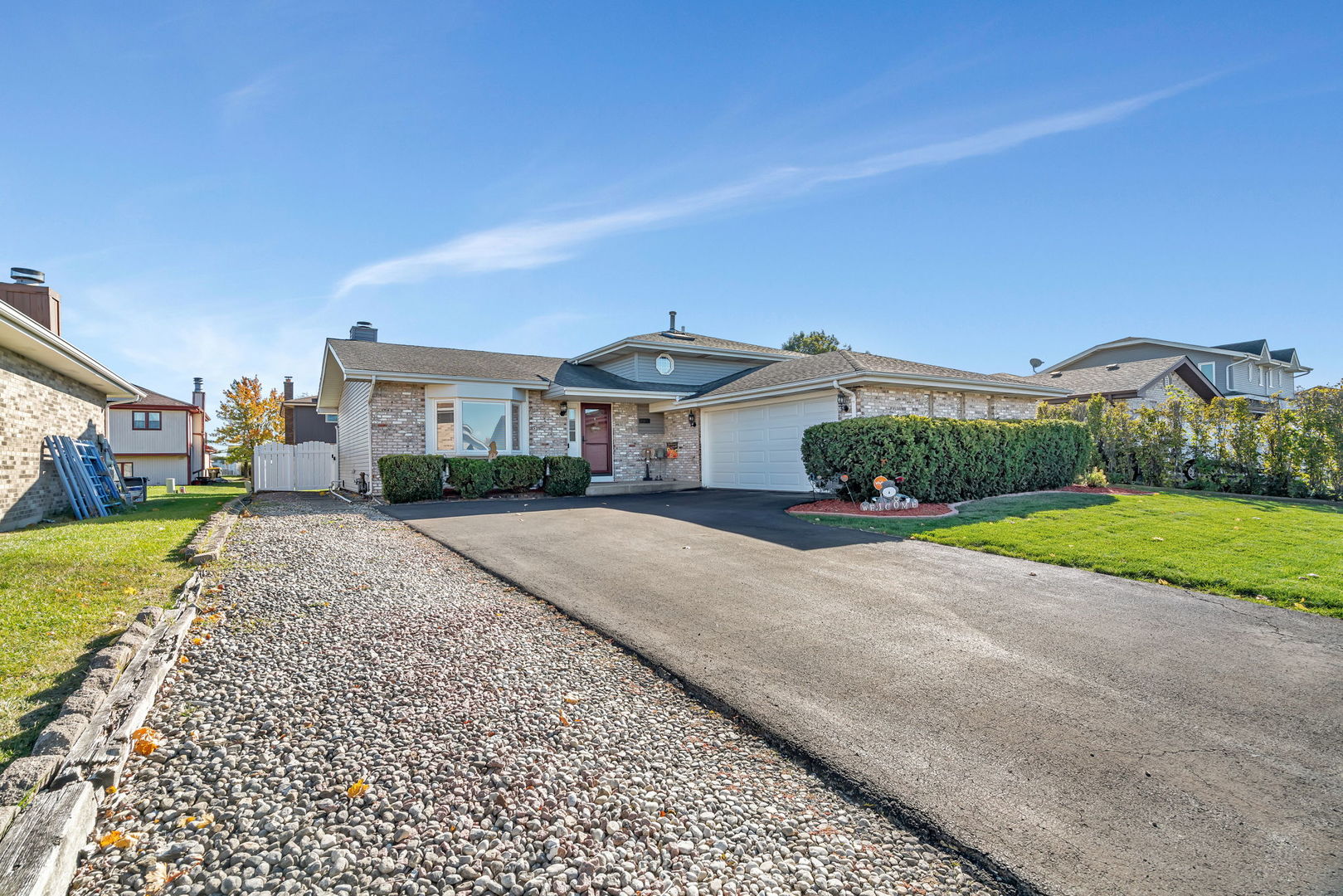 20107 Arroyo Avenue Lynwood, IL 60411 - Photo 1 of 33 a front view of a house with a yard and garage