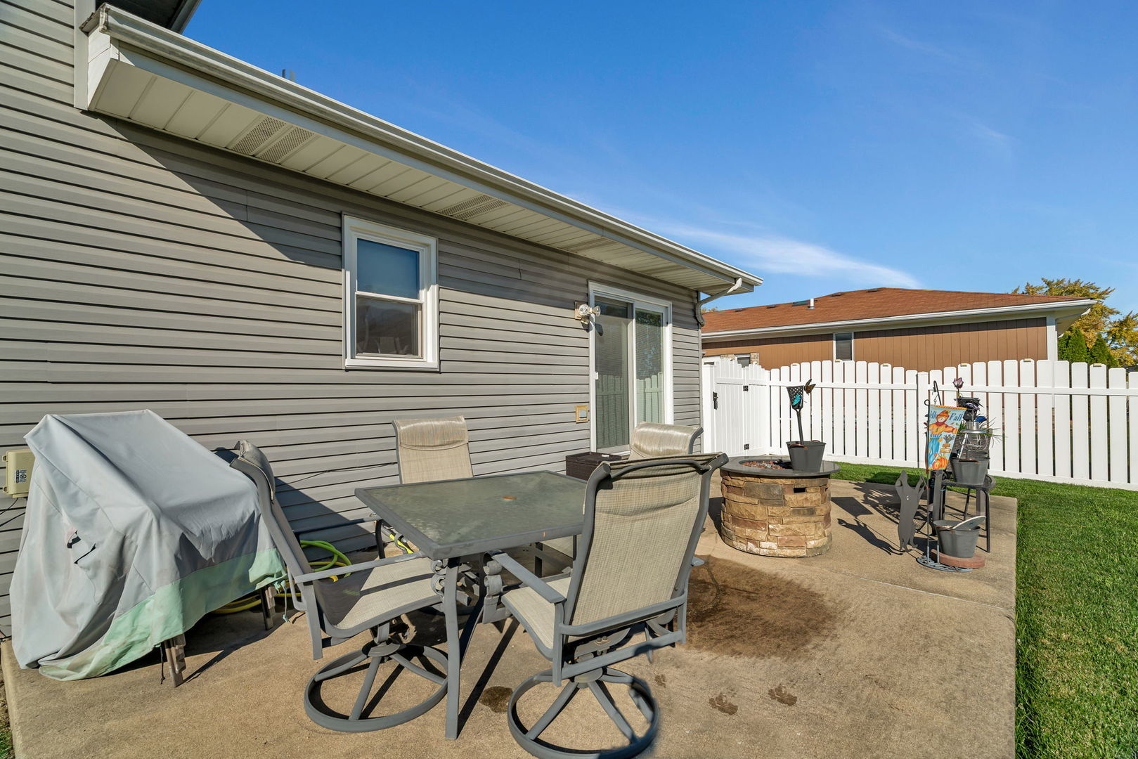 20107 Arroyo Avenue Lynwood, IL 60411 - Photo 24 of 33 a view of a patio with table and chairs with wooden fence