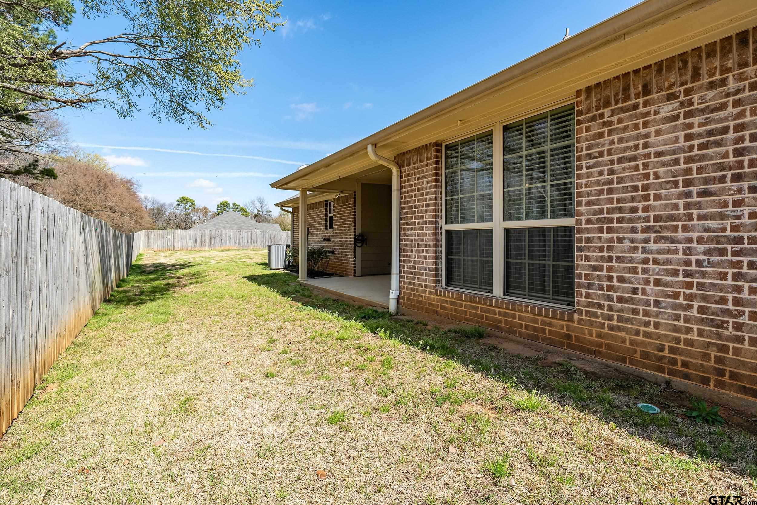 421 West Cumberland Road, Unit 205 Tyler, TX 75703 - Photo 24 of 24 a view of yellow house with a yard