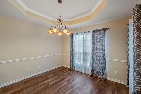 a view of a room with wooden floor chandelier and closet