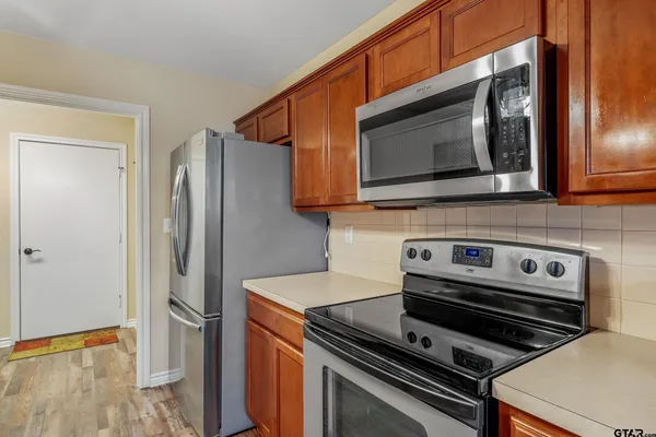 a kitchen with appliances and a microwave