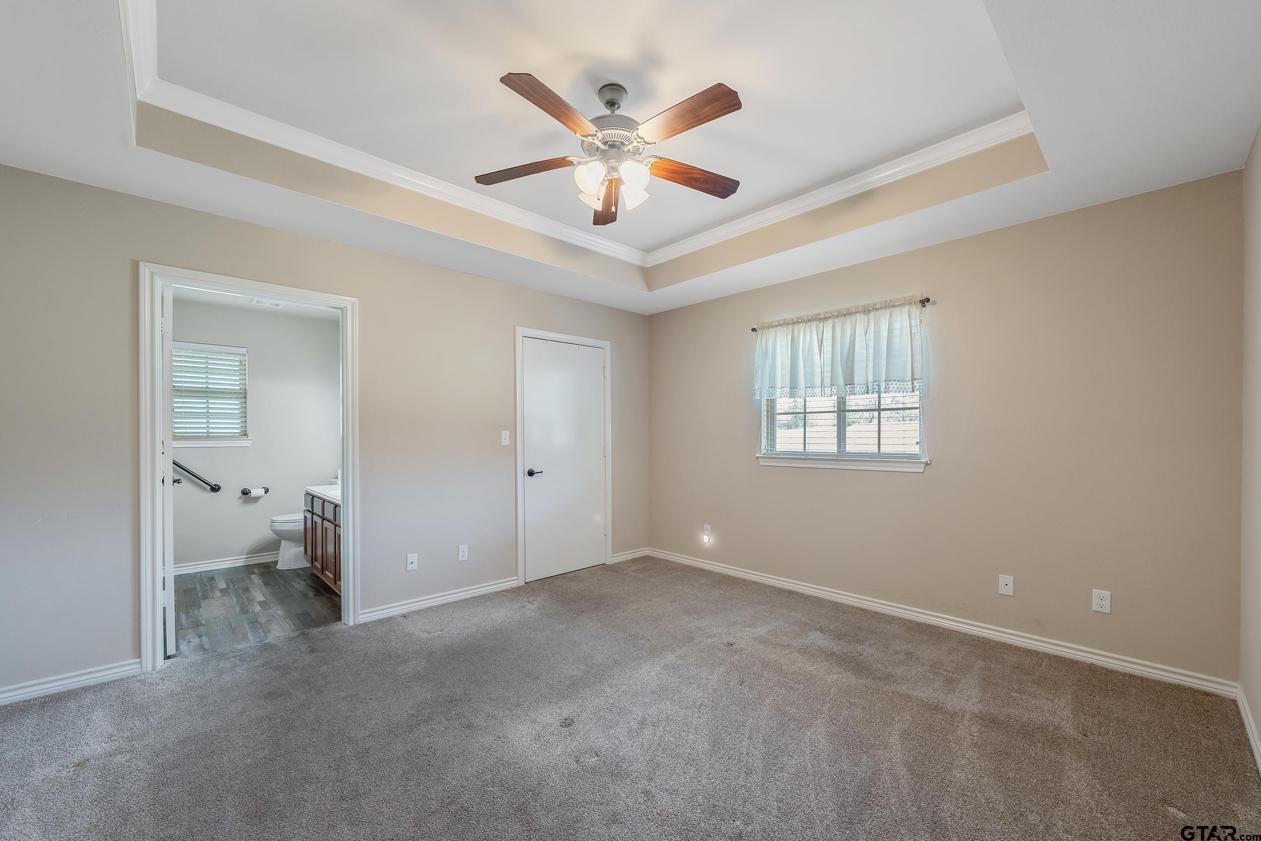 421 West Cumberland Road, Unit 205 Tyler, TX 75703 - Photo 8 of 24 a view of an empty room with a ceiling fan and window