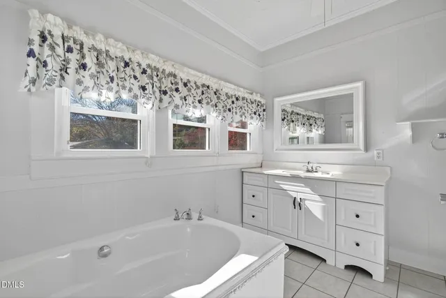 a white bath tub sitting next to a window