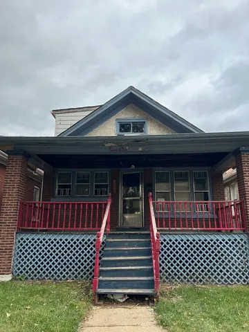a front view of a house with wooden fence