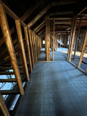 a view of water heater room with staircase