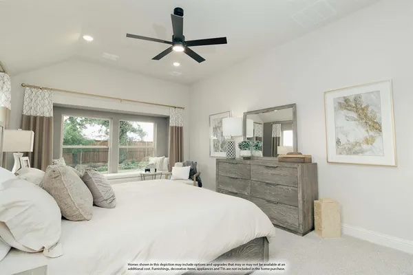 a bedroom with a large bed and chandelier