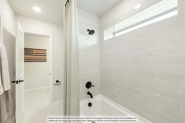 a bedroom with a bed and a large mirror