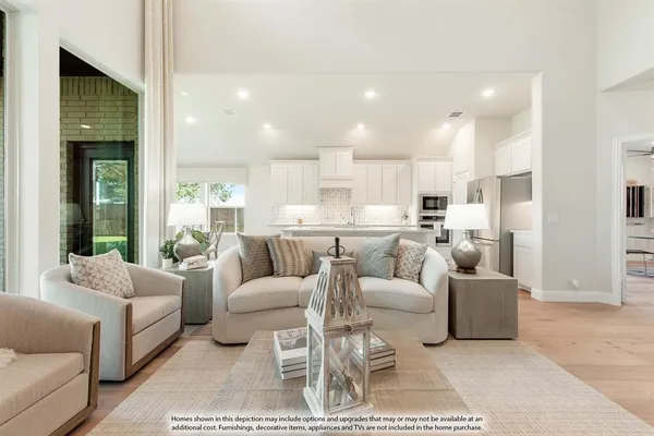a kitchen with stainless steel appliances a sink a stove and white cabinets