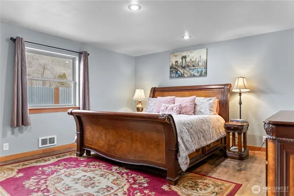 a bed sitting in a bedroom next to a window