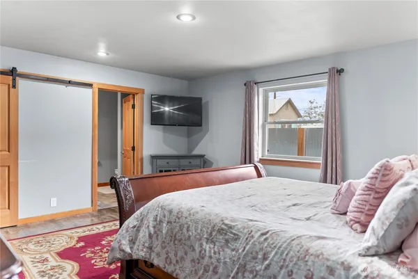 a bedroom with a bed and a window