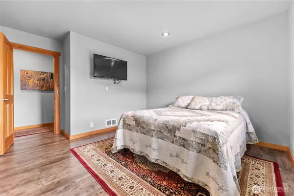 a bedroom with a bed and a flat screen tv