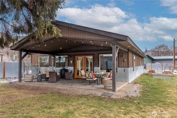 a view of a house with backyard porch and sitting area