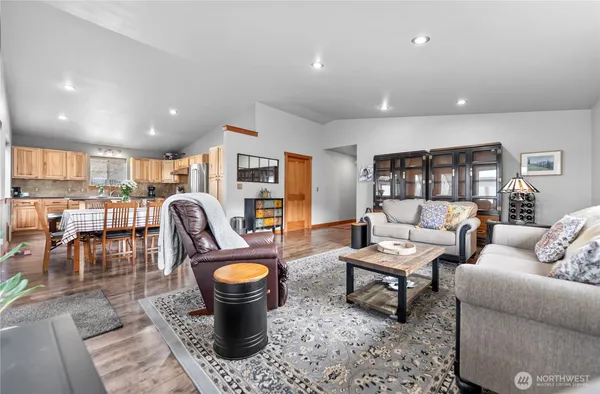 a living room with furniture and view of kitchen