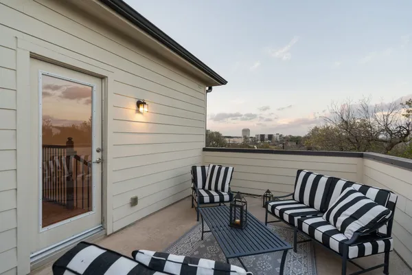 a balcony with table and chairs