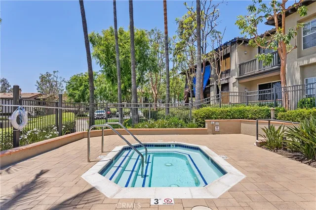 a view of a swimming pool with chairs in patio