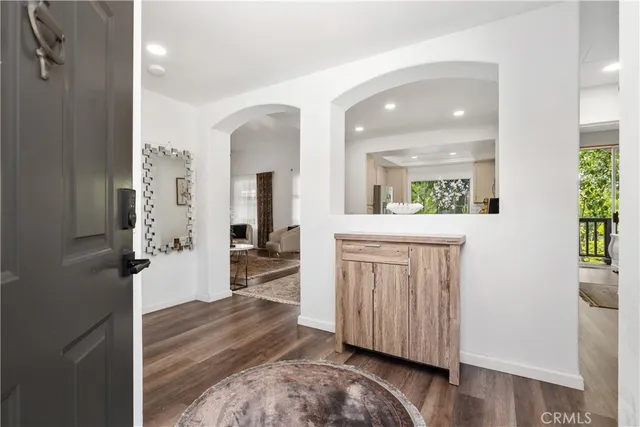 a view of a hallway with wooden floor windows and livingroom