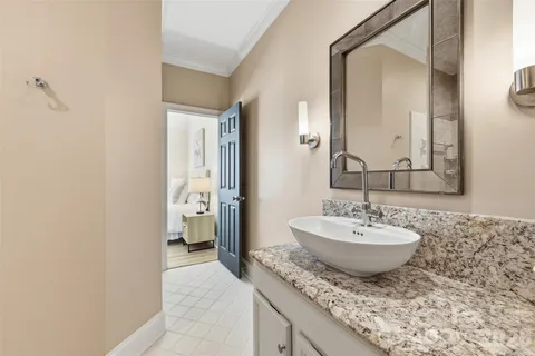 a spacious bathroom with a granite countertop sink and a mirror