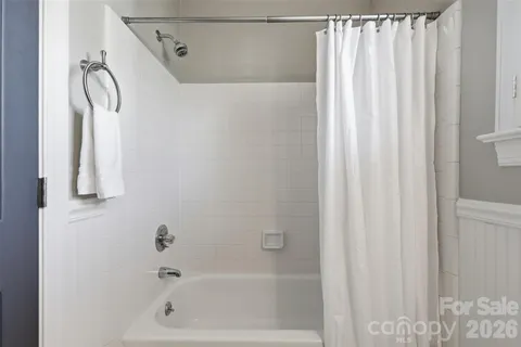 a bathroom with a shower curtain and a shower