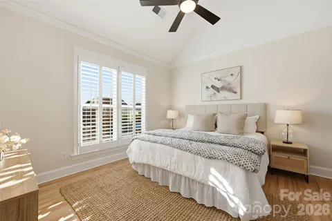 a bedroom with a large bed and a window