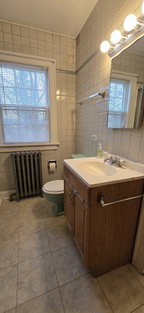405 Opatrny Drive Fox River Grove, IL 60021 - Photo 6 of 9 a bathroom with a sink a toilet and shower